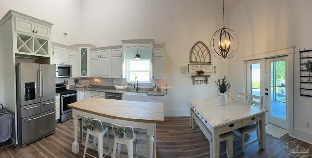 a kitchen with stainless steel appliances kitchen island granite countertop a sink counter space and cabinets