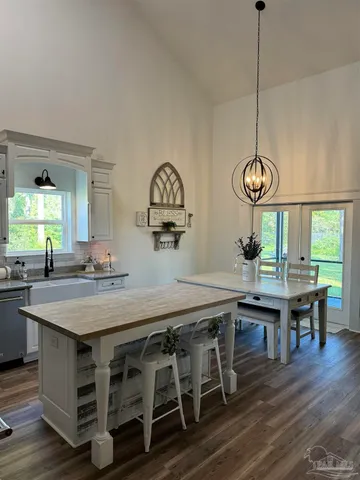 a view of entryway and kitchen with wooden floor