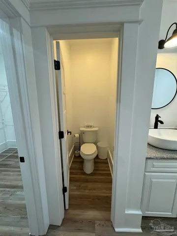 a view of a closet area with an empty room and wooden floor