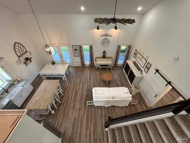 a view of a hallway with wooden floor and glass door