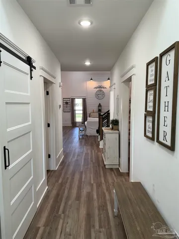 a room with pool table and wooden floor