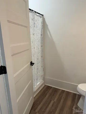 a bathroom with a sink a toilet and mirror