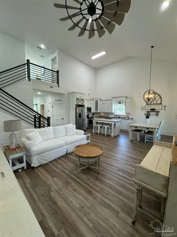 a living room with furniture and a wooden floor