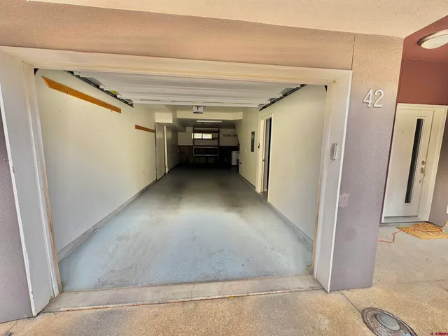 a view of water heater room with cabinet and stairs