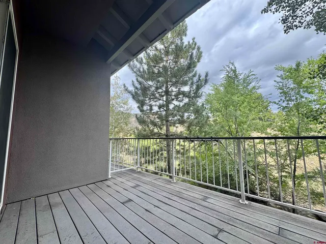 a view of balcony with wooden floor