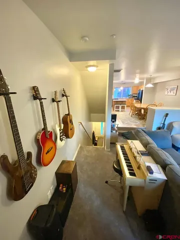 a bedroom with furniture and a view of living room