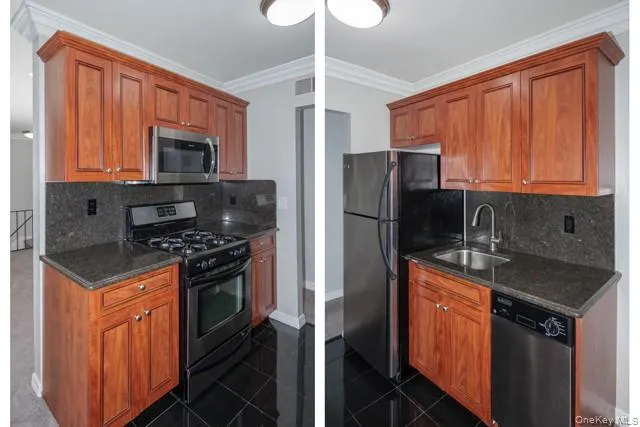 a kitchen with stainless steel appliances granite countertop a stove top oven a refrigerator and a sink with granite countertops