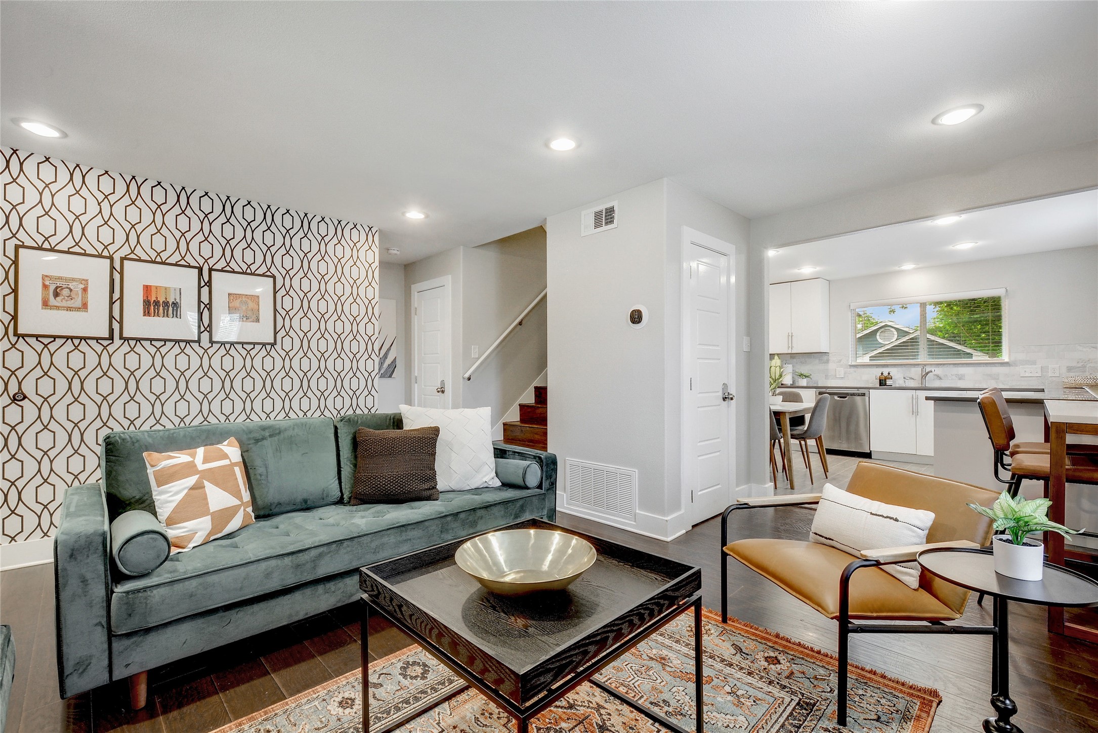 Undisclosed Address Austin, TX 78721 - Photo 2 of 35 Living room featuring wood finished floors, an accent wall, recessed lighting, and wallpapered walls