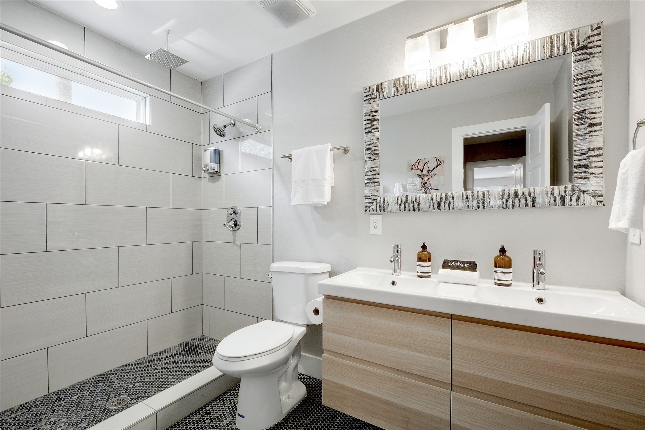 Undisclosed Address Austin, TX 78721 - Photo 22 of 35 Bathroom with double vanity, a shower stall, and tile patterned floors