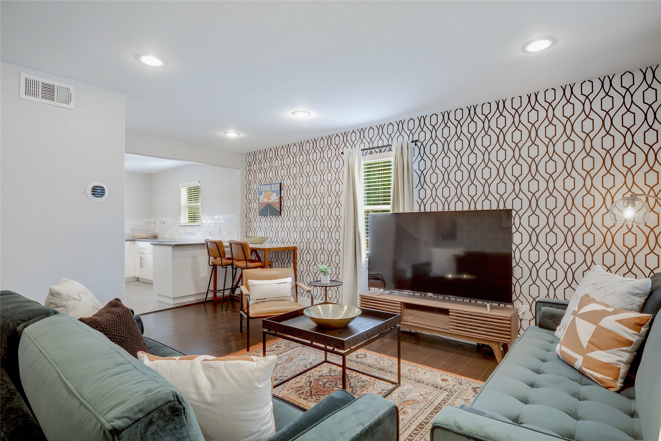Undisclosed Address Austin, TX 78721 - Photo 3 of 35 Living room featuring wood finished floors, plenty of natural light, and wallpapered walls