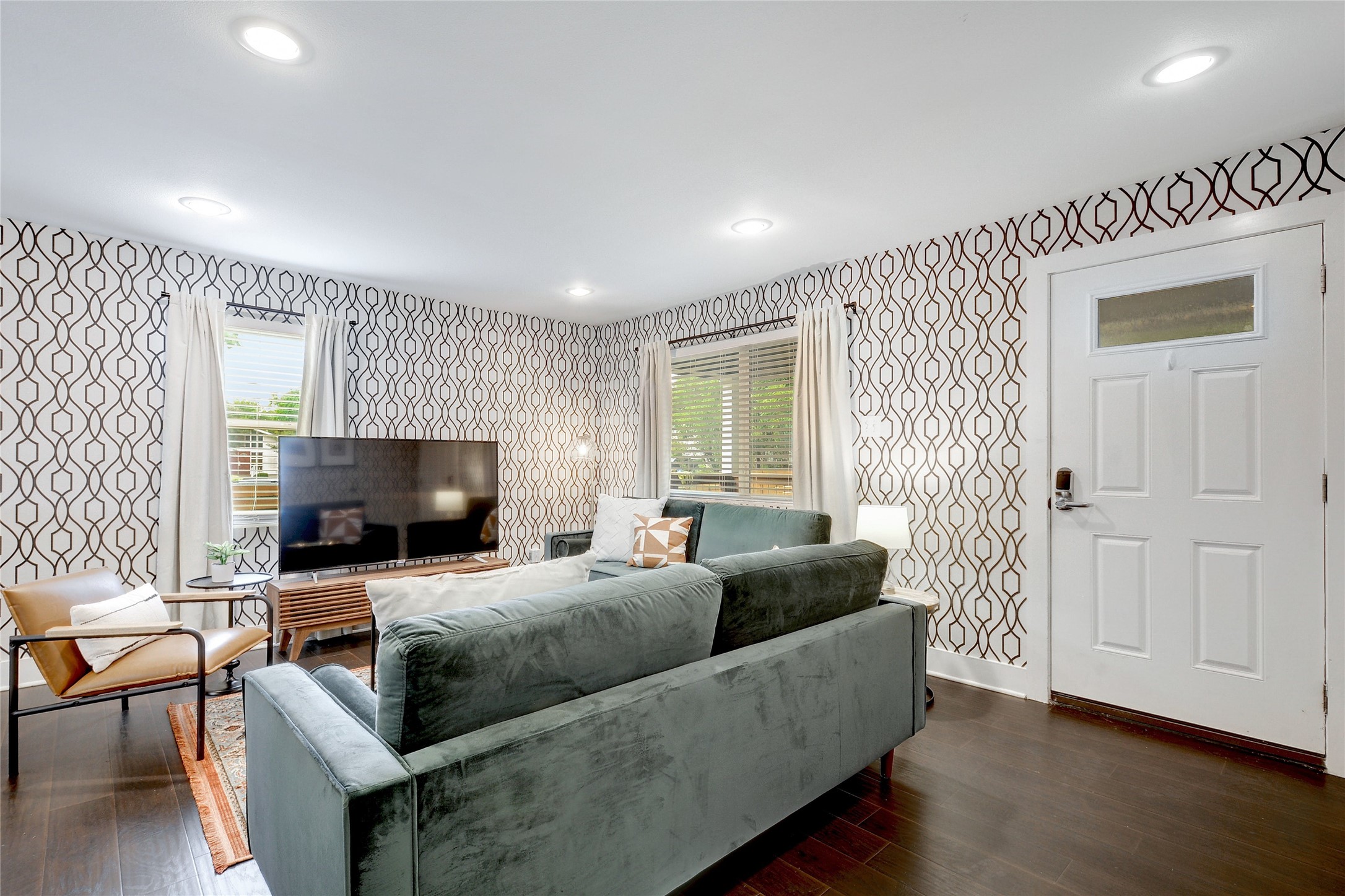 Undisclosed Address Austin, TX 78721 - Photo 4 of 35 Living room with dark wood-style flooring, wallpapered walls, and recessed lighting