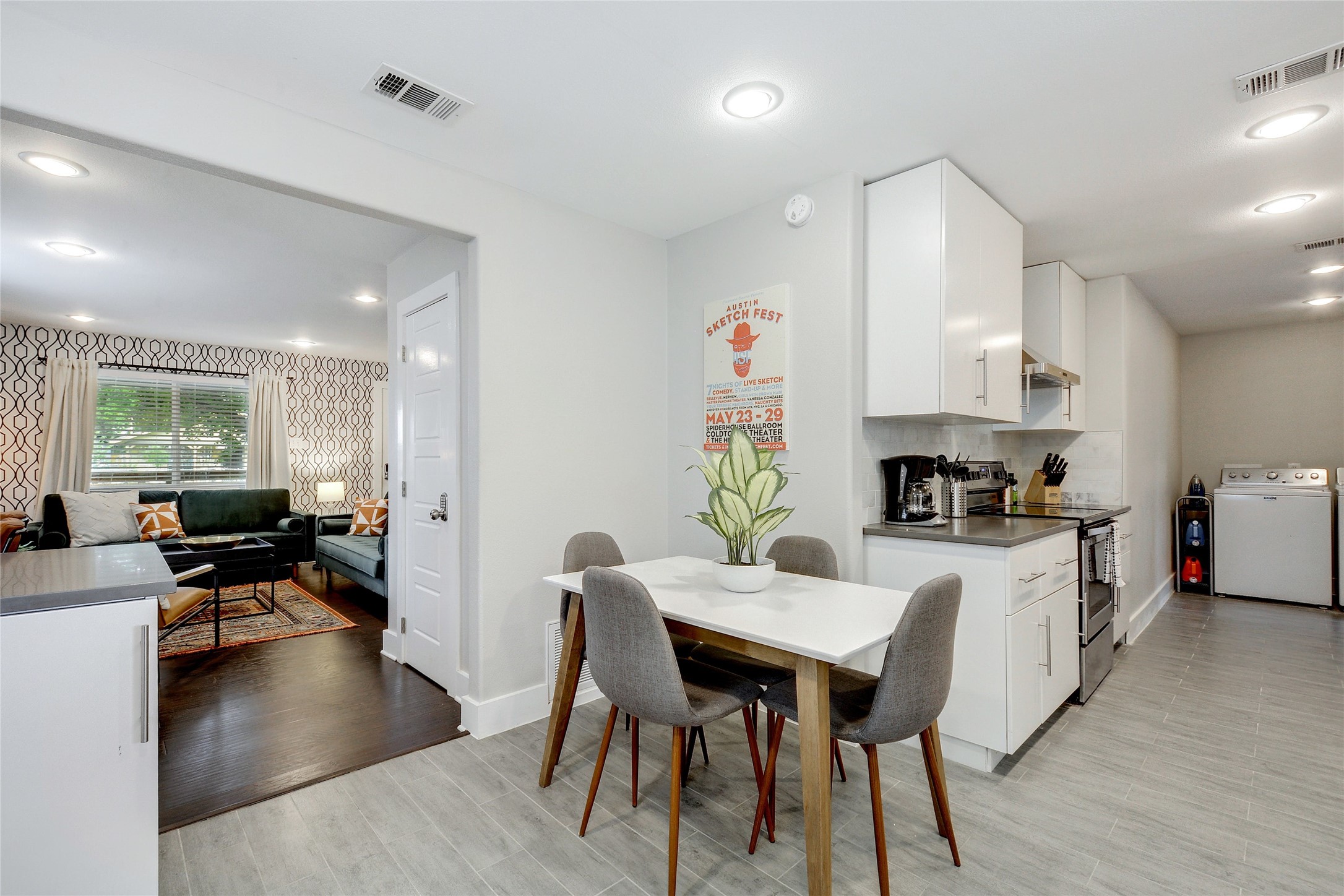 Undisclosed Address Austin, TX 78721 - Photo 8 of 36 a kitchen with a dining table chairs stove a sink and a refrigerator