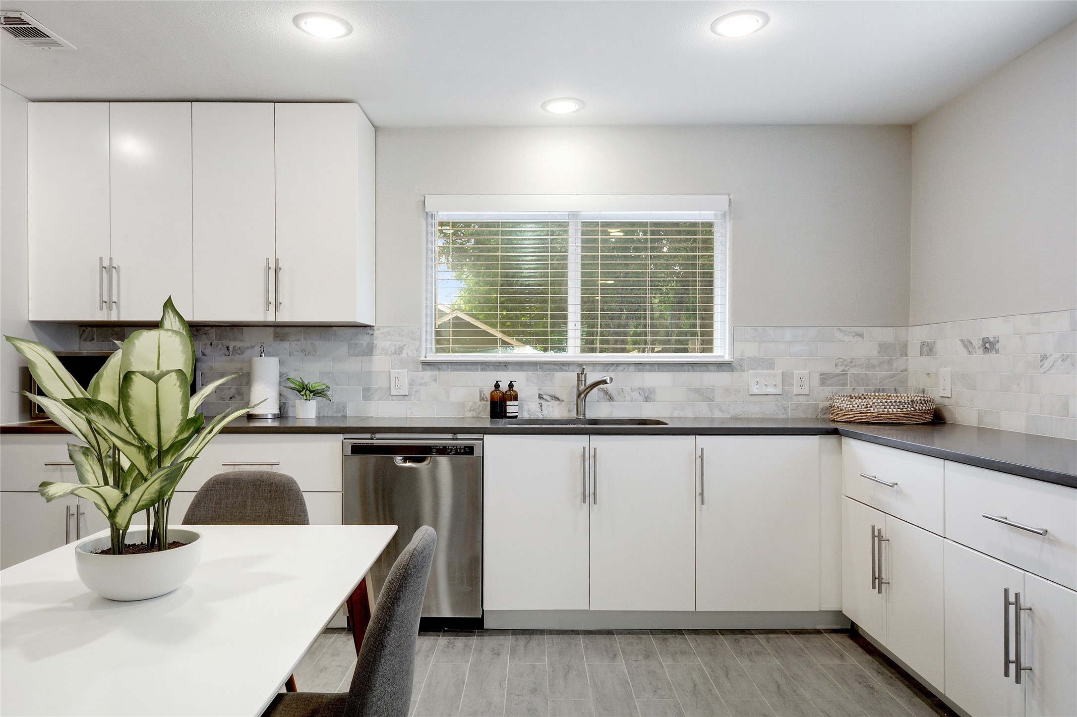 Undisclosed Address Austin, TX 78721 - Photo 9 of 35 Kitchen featuring white cabinetry, dishwasher, light wood-style floors, and recessed lighting