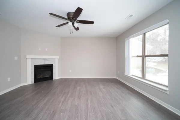 a kitchen with stainless steel appliances granite countertop a refrigerator a stove a sink dishwasher a dining table and chairs with wooden floor