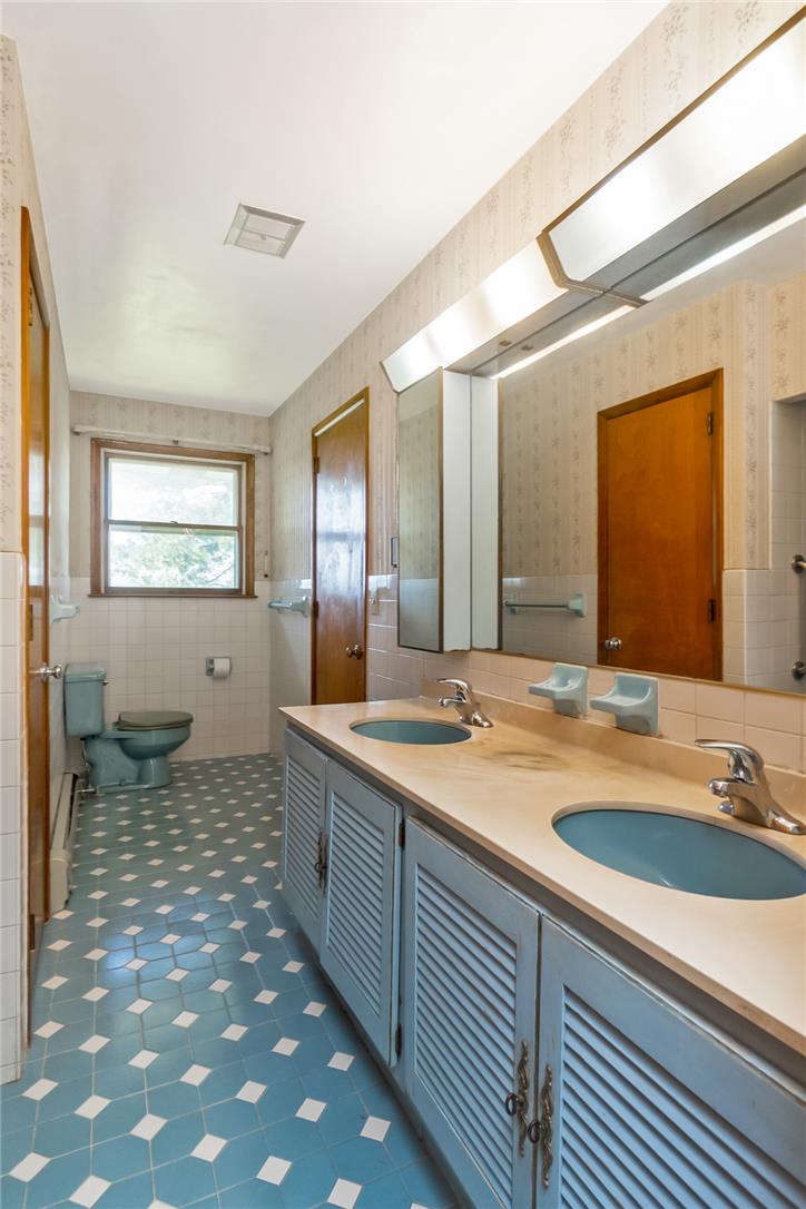 1657 Clearview Road Coplay, PA 18037 - Photo 55 of 77 A vintage bathroom featuring a double vanity with twin basins and a spacious mirror above.