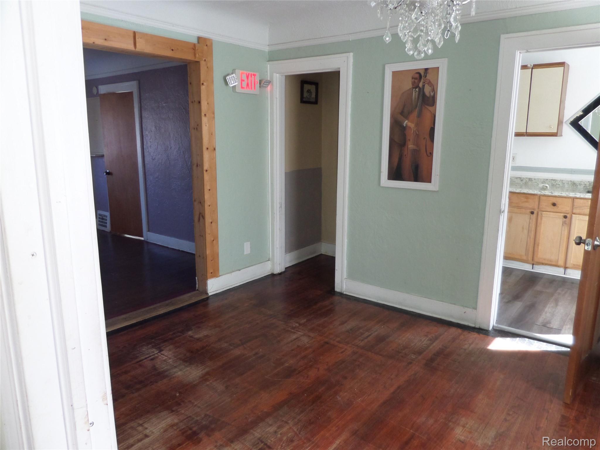 384 Perry Street Pontiac, MI 48342 - Photo 19 of 28 Unit 3 Unfurnished dining area with dark wood-style flooring and a chandelier