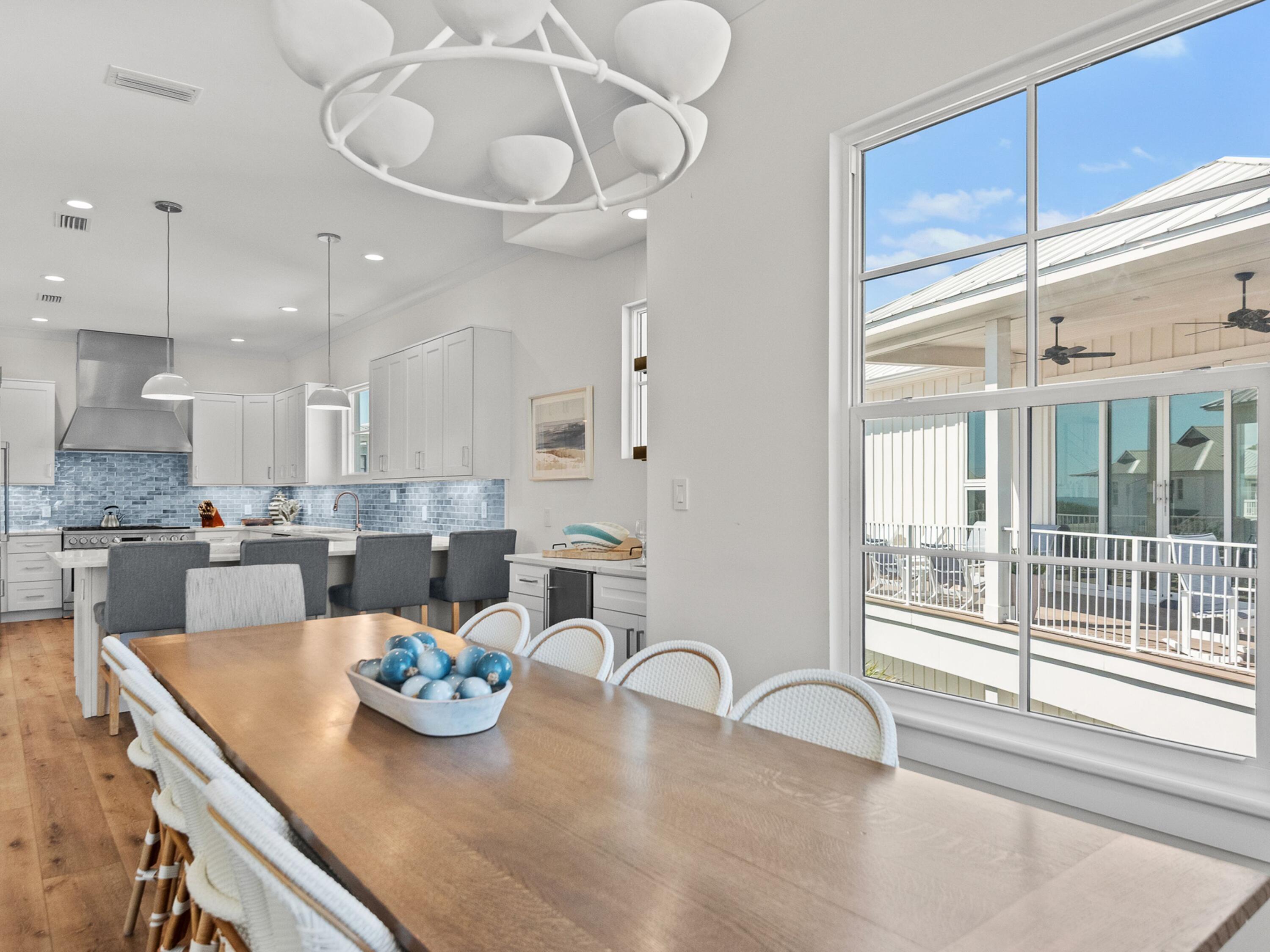 50 Camelot Lane Santa Rosa Beach, FL 32459 - Photo 13 of 39 a kitchen with stainless steel appliances kitchen island granite countertop a table and chairs in it