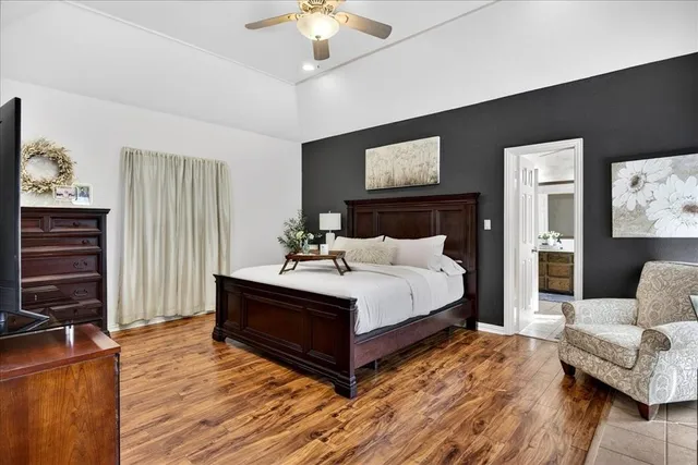 a bedroom with a bed and wooden floor