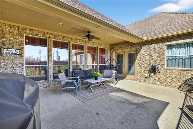 a backyard of a house with table and chairs