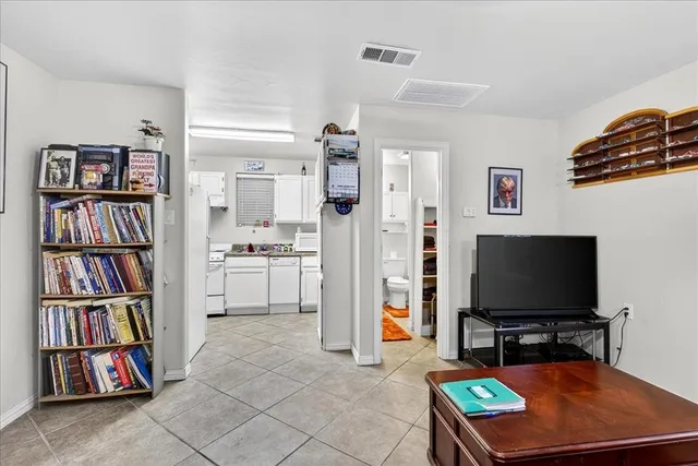 a kitchen with white cabinets and white appliances