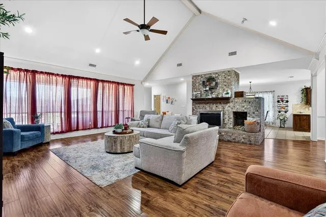 a living room with furniture wooden floor and a fireplace