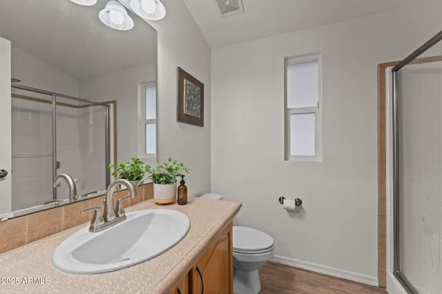 a bathroom with a sink toilet and shower