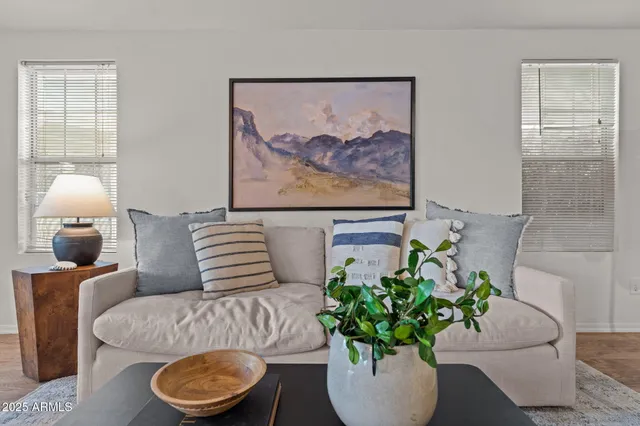 a living room with furniture flowerpot and window