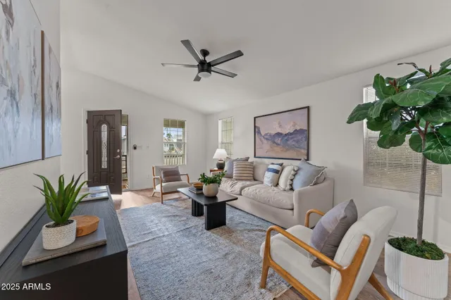 a living room with furniture potted plant and a window