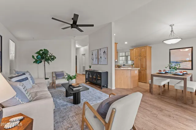 a living room with furniture fireplace and dining table
