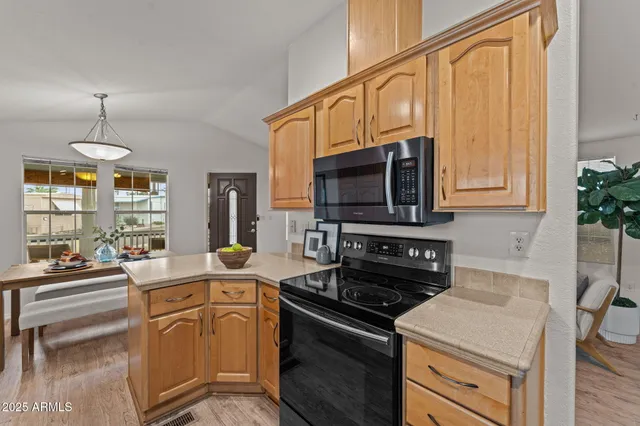 a kitchen with stainless steel appliances a stove a sink and a microwave