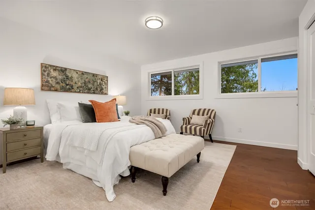 a spacious bedroom with a bed and a couch