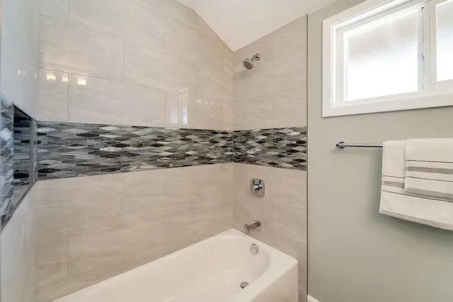 a bathroom with a bathtub and a shower
