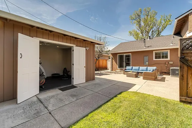 a view of a patio with couches and potted plants
