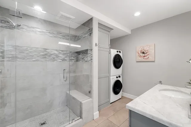 a bathroom with a granite countertop sink a toilet and a mirror