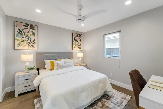 a bedroom with a bed a desk and chair