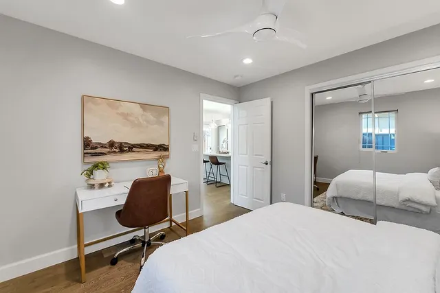 a bedroom with a bed and a lamp