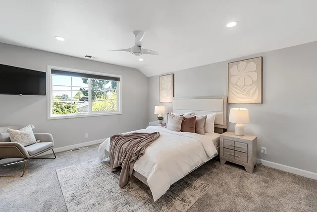 a bedroom with a bed and a window