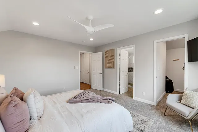 a bedroom with a large bed couch and a window