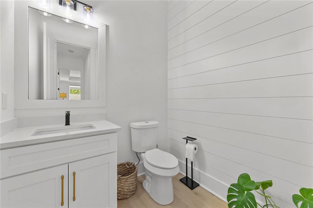 2694 Thompson Mill Road Buford, GA 30519 - Photo 35 of 70 a bathroom with a toilet sink and mirror