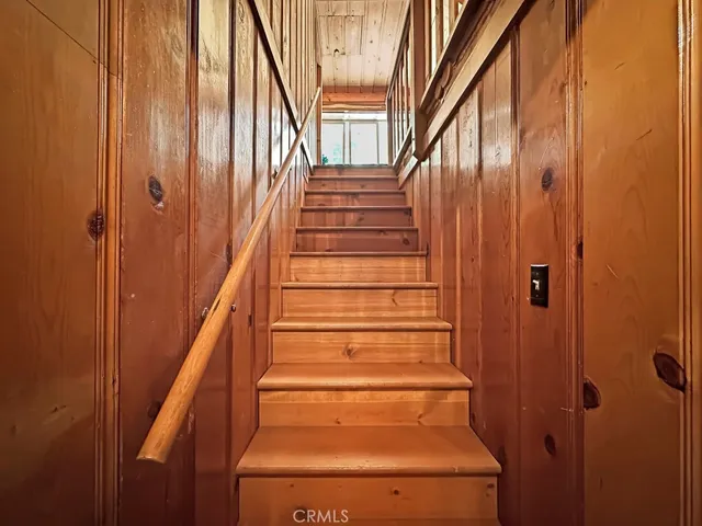 a view of a patio with table and chairs with wooden floor and fence