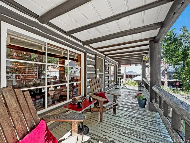 a view of a balcony with chairs and wooden floor