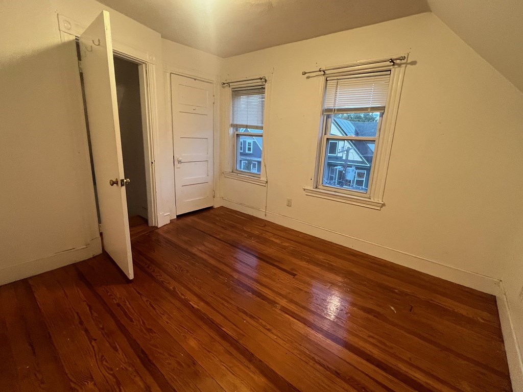 178 Larch Road Cambridge, MA 02138 - Photo 11 of 15 an empty room with wooden floor and windows