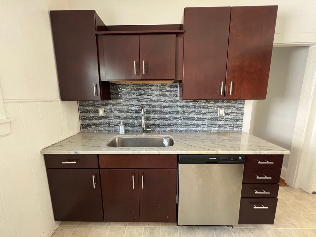 178 Larch Road Cambridge, MA 02138 - Photo 2 of 15 a kitchen with a sink a microwave and cabinets