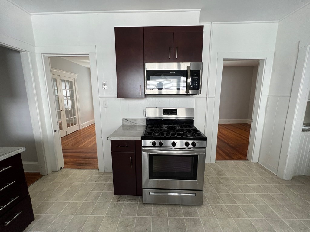 178 Larch Road Cambridge, MA 02138 - Photo 3 of 15 a kitchen with a stove and a microwave