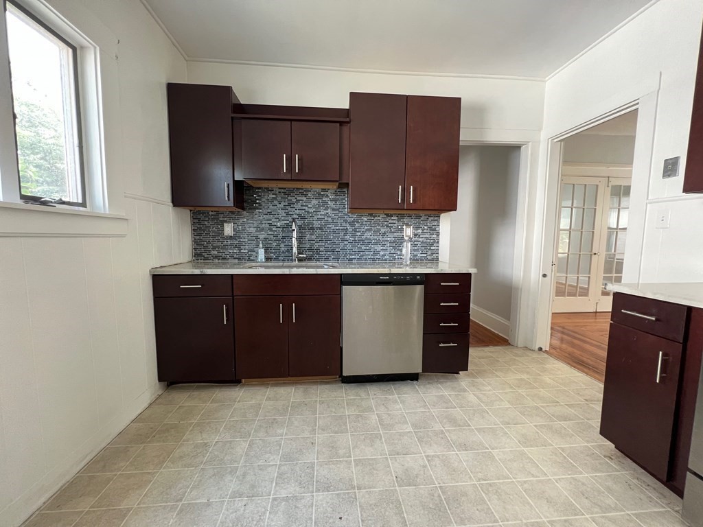178 Larch Road Cambridge, MA 02138 - Photo 5 of 15 a kitchen with stainless steel appliances granite countertop a stove a refrigerator and a cabinets