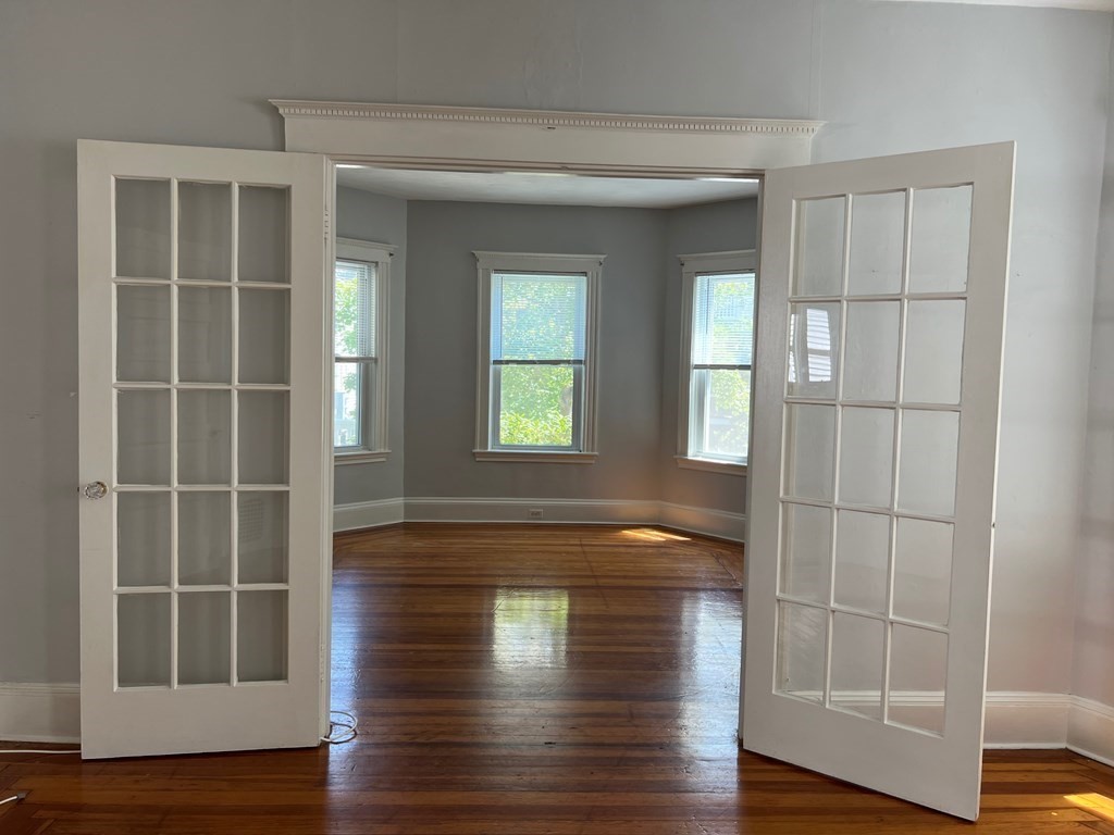 178 Larch Road Cambridge, MA 02138 - Photo 7 of 15 a view of empty room with wooden floor and fan