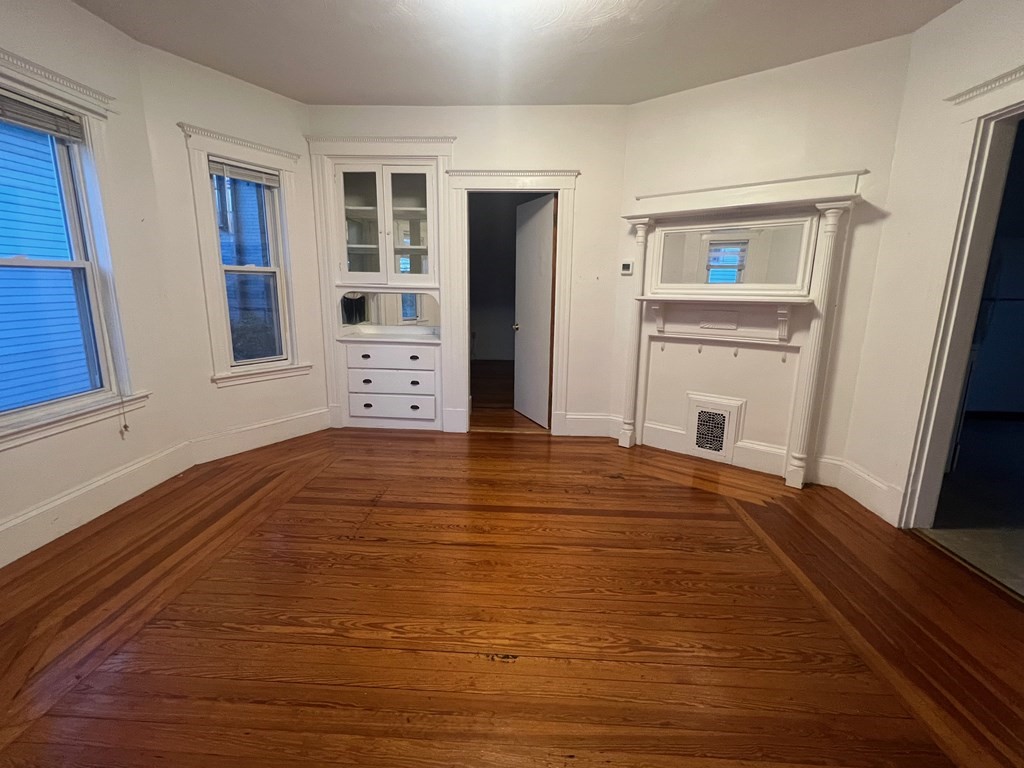 178 Larch Road Cambridge, MA 02138 - Photo 10 of 15 a view of an empty room with window and wooden floor