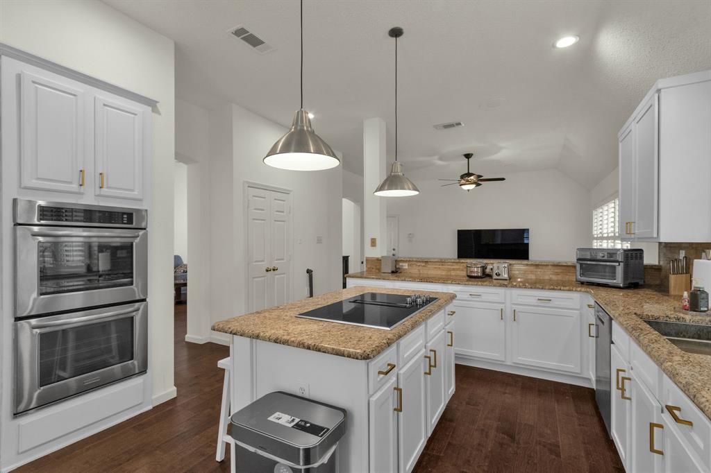 a kitchen with a stove sink and a refrigerator