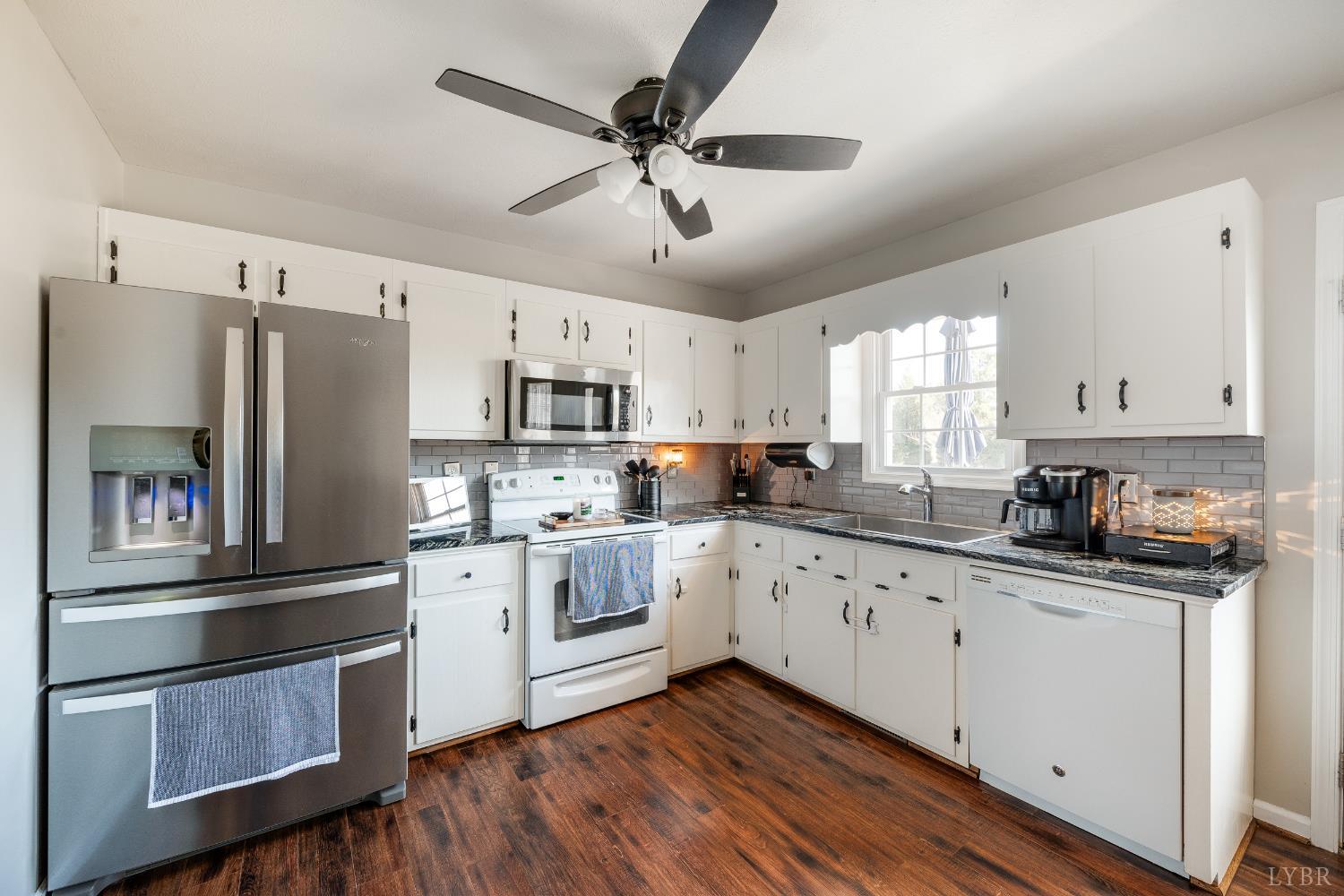 746 Church Street Appomattox, VA 24522 - Photo 11 of 36 a kitchen with granite countertop white cabinets and white stainless steel appliances