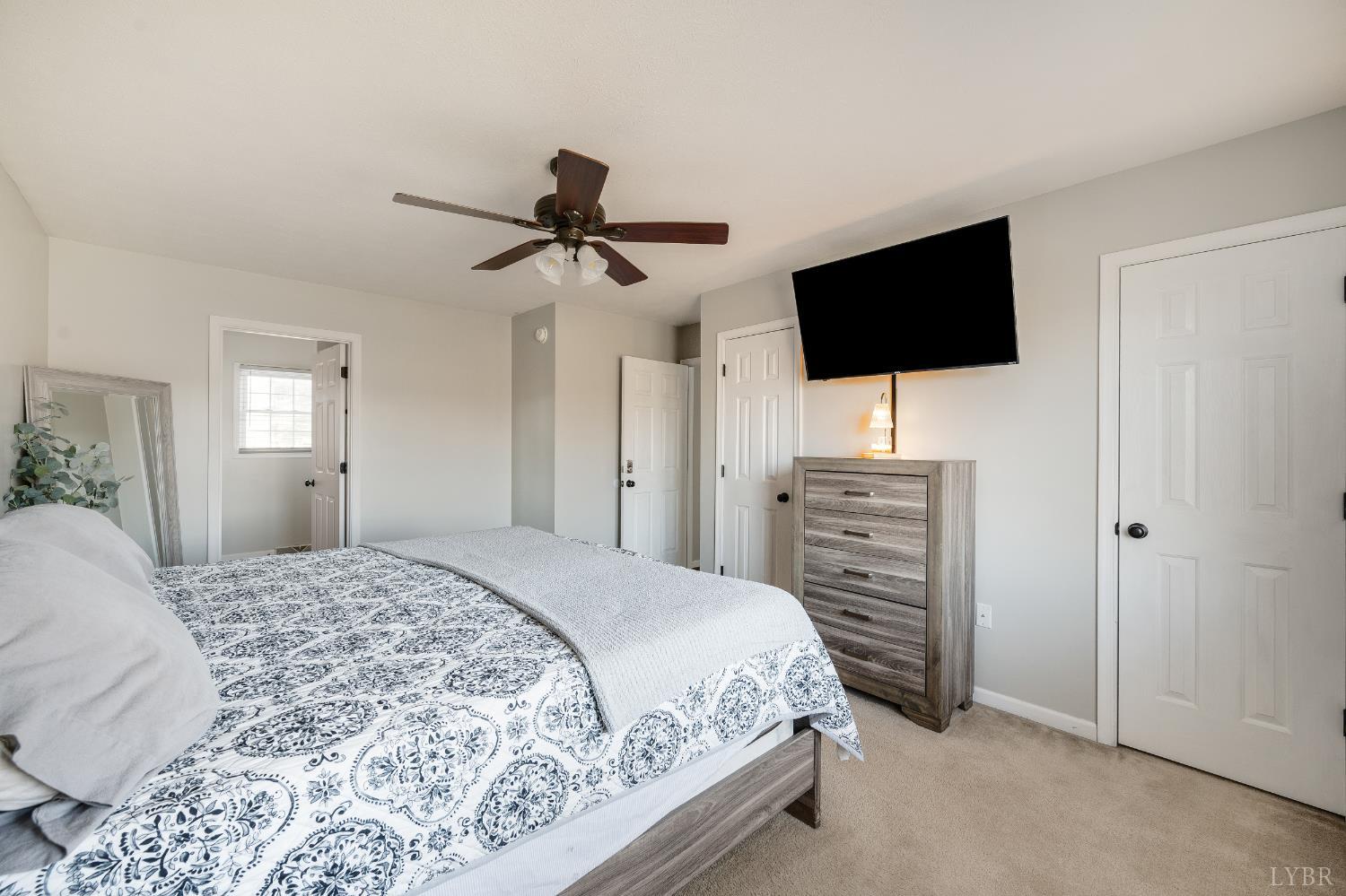 746 Church Street Appomattox, VA 24522 - Photo 15 of 36 a bedroom with a bed a flat tv screen and a dresser